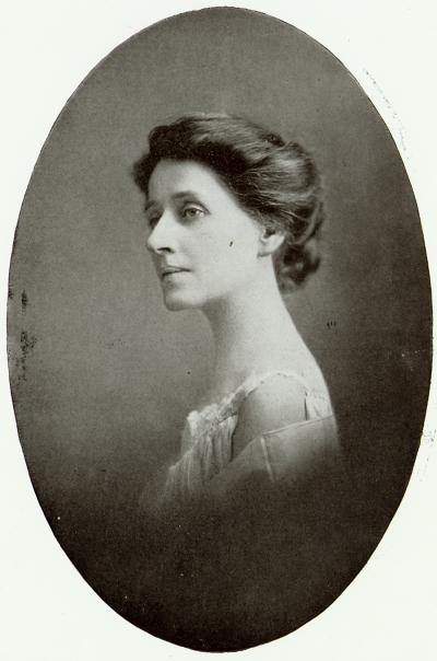 black and white photo of a woman with hair up in a white nightgown looking to the left