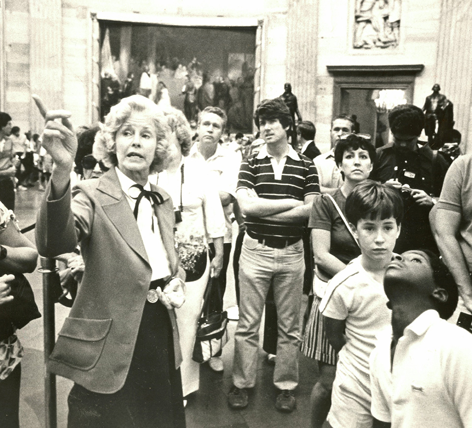 A guide leading a tour of guests. 