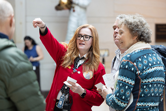 Visitor Assistant directing a couple to a location. 