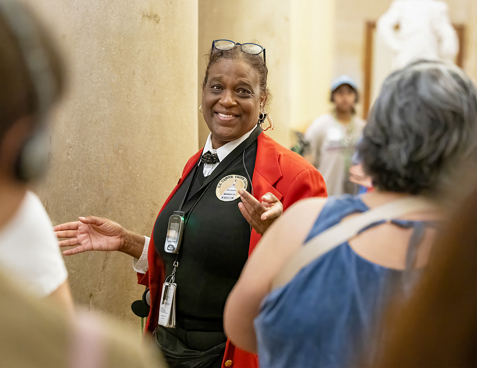 Female guide interacts with visitors.