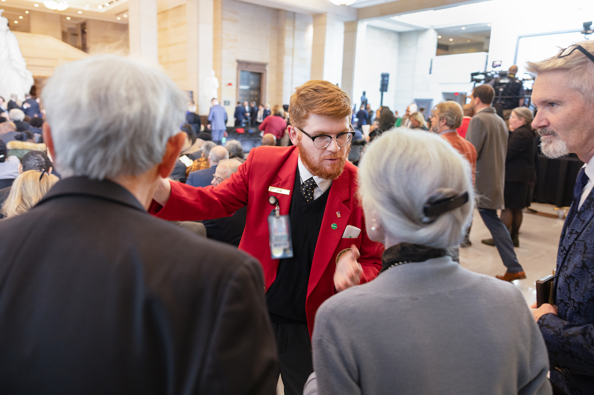 A guide assisting visitors during a special event.