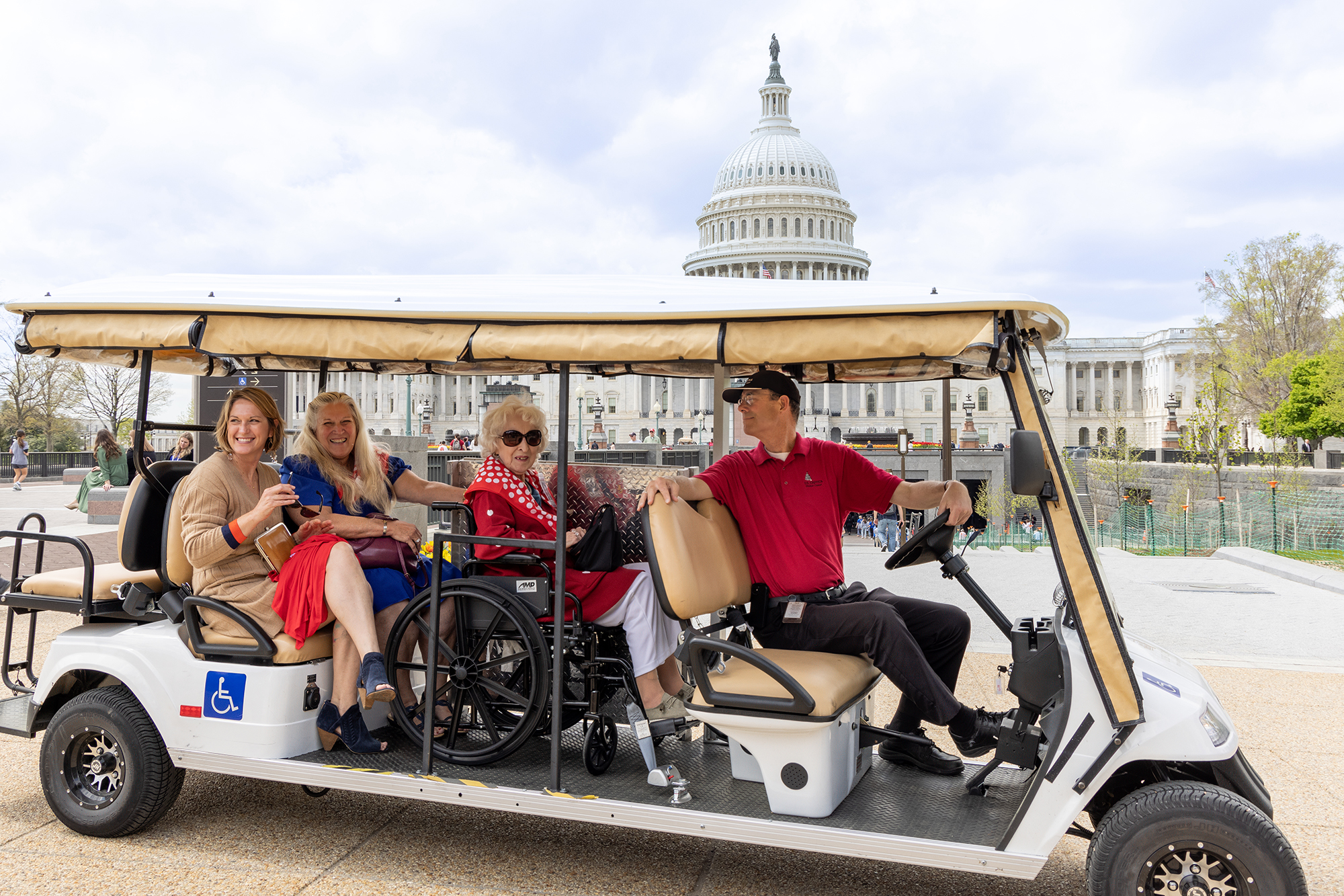 A golf cart with four people in it. 