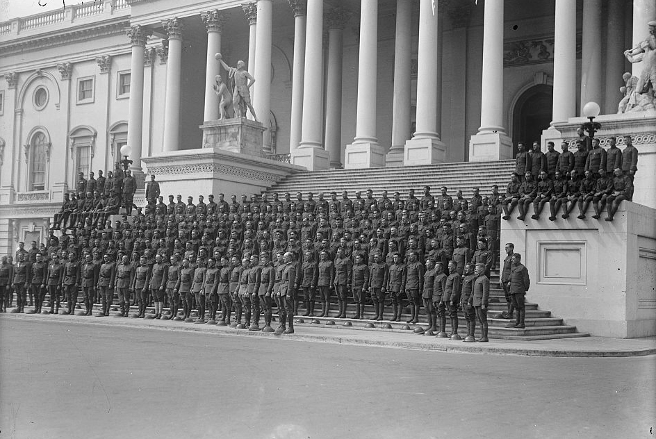A black and white photo of WWI soldiers standing on the steps of the Capitol.