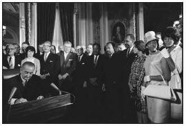 President Lyndon B. Johnson signing the Civil Rights Act of 1965