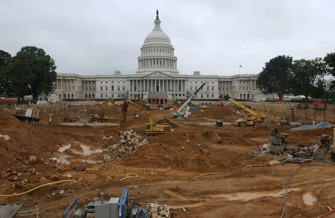 Capitol building during construction with exposed dirt and heavy equipment. 