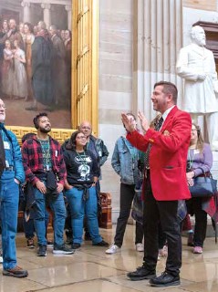 Tour guide talking to visitors.