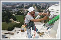 a man is suspended from outside the capitol painting 