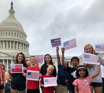 group of students standing outside the Capitol holding paper flags