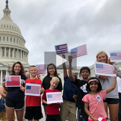 Children outside the US Capitol waving flags