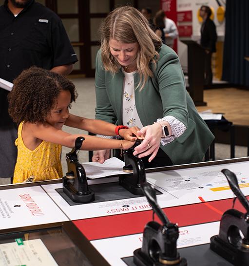 Woman helping child in Democracy Lab