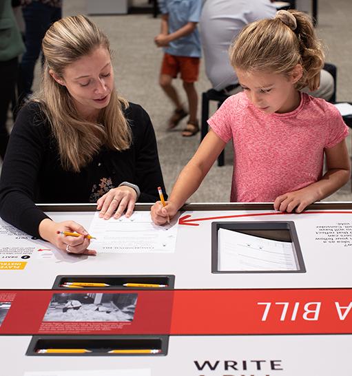 Education specialist with child in Democracy Lab