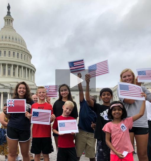 Children outside the US Capitol waving flags