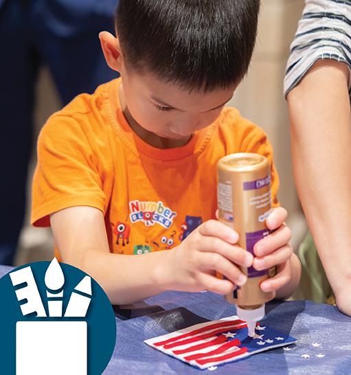 Child gluing stars on a paper American flag. 