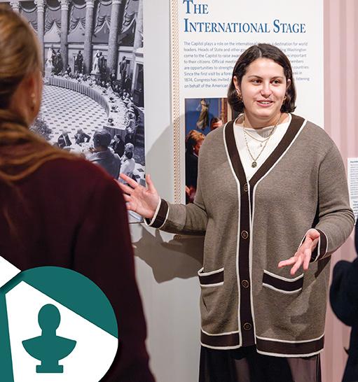 A female talking about information at a display.