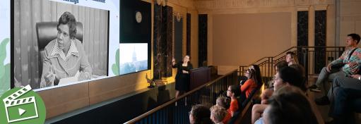 People watching a large screen.