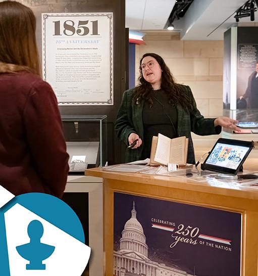 a person gestures to the Declaration of Sentiments on display in Exhibition Hall