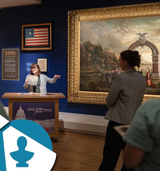 a person gestures to the Colorado painting on display in Exhibition Hall