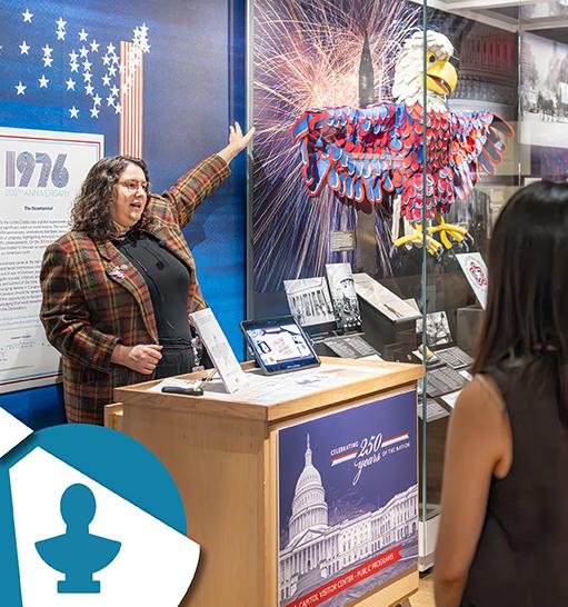 A person points at the Arba the Eagle puppet on display in Exhibition Hall