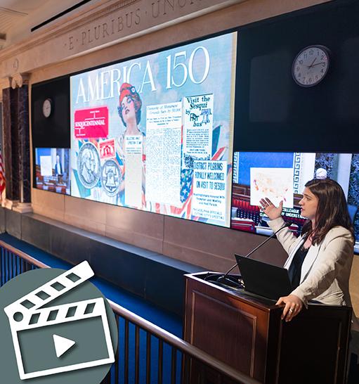 person gestures to a theater screen in Exhibition Hall