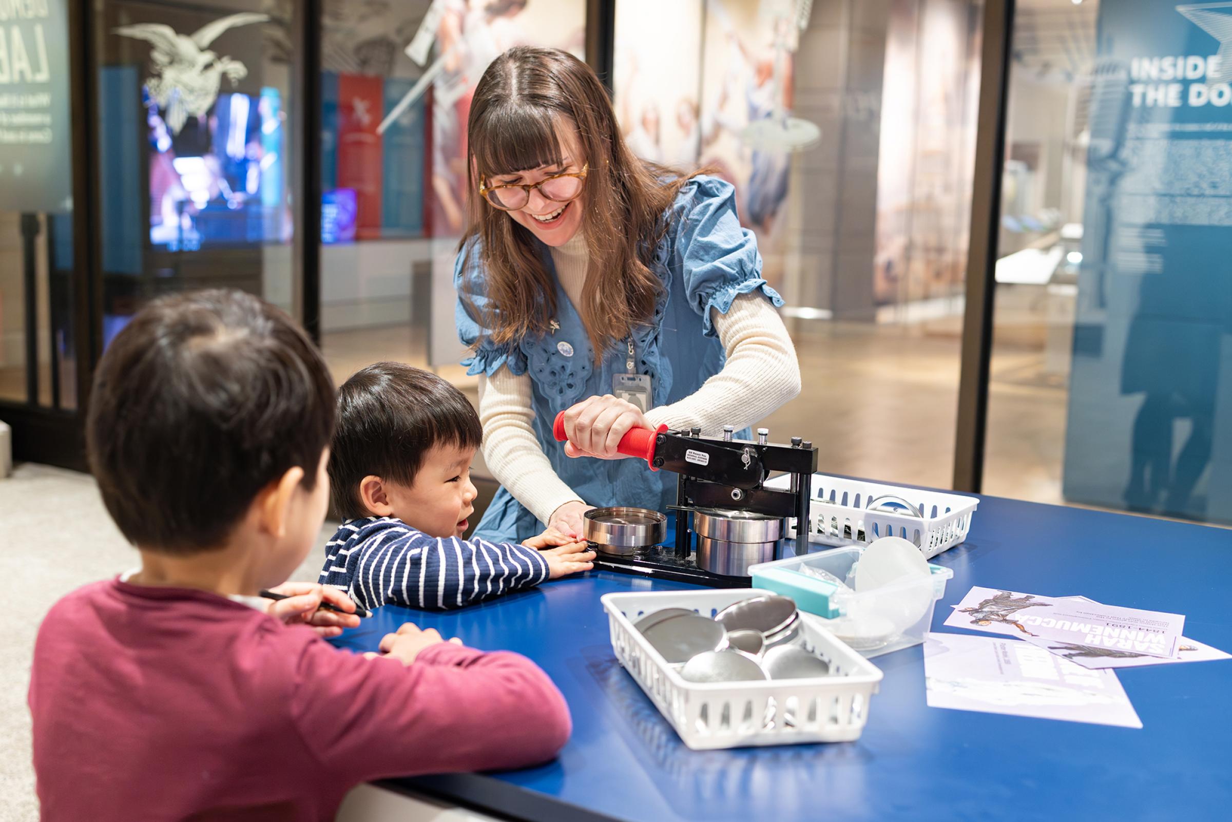 Woman interacting with two children. 