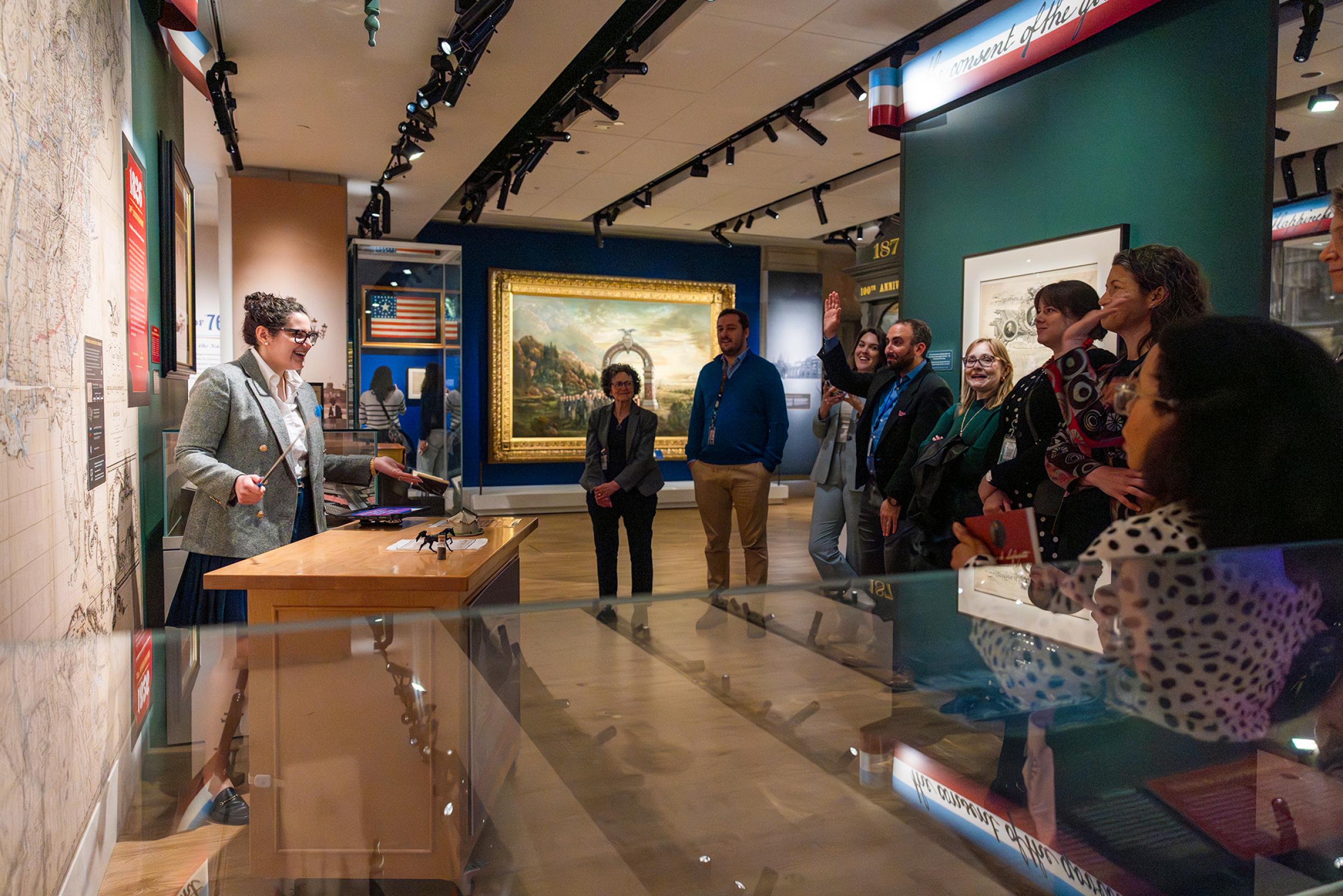 A woman giving a presentation to visitors. 