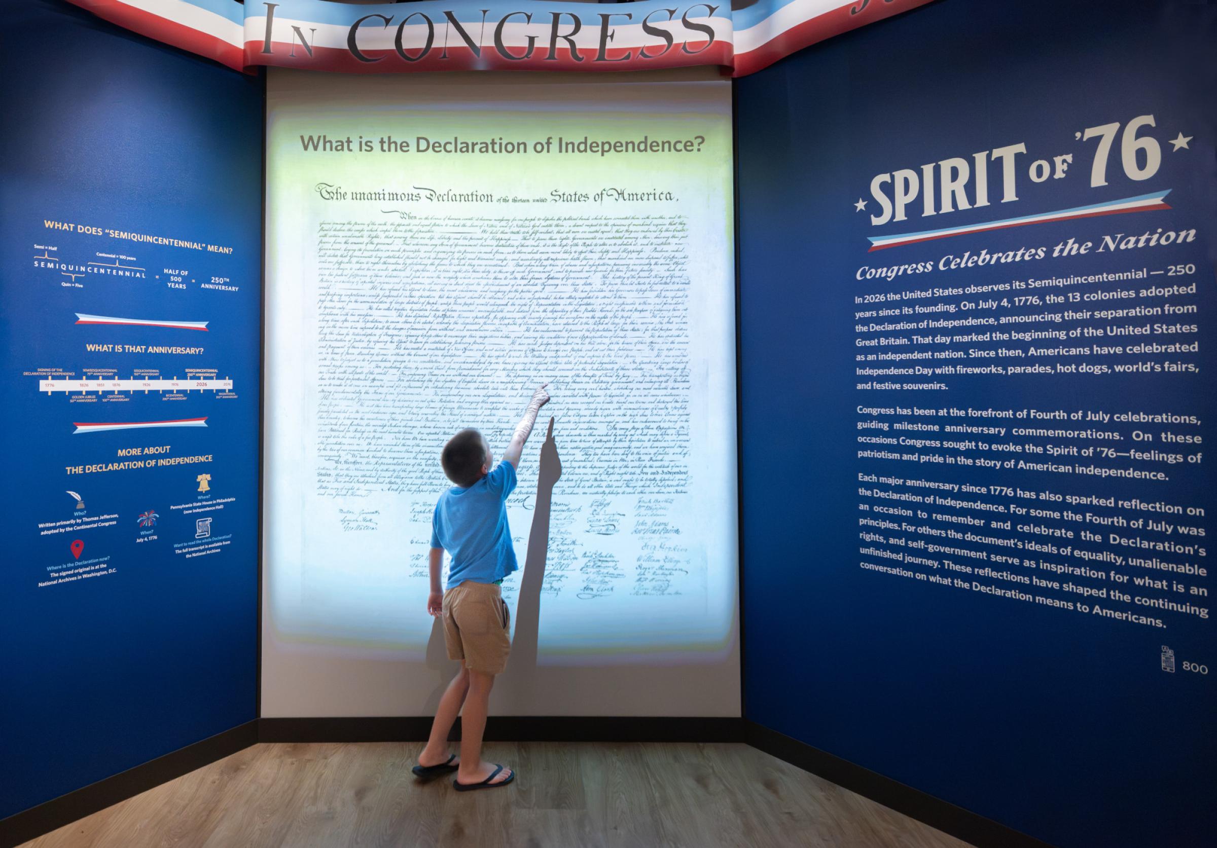 child pointing at the Declaration of Independence animation in the Spirit of '76 special exhibit