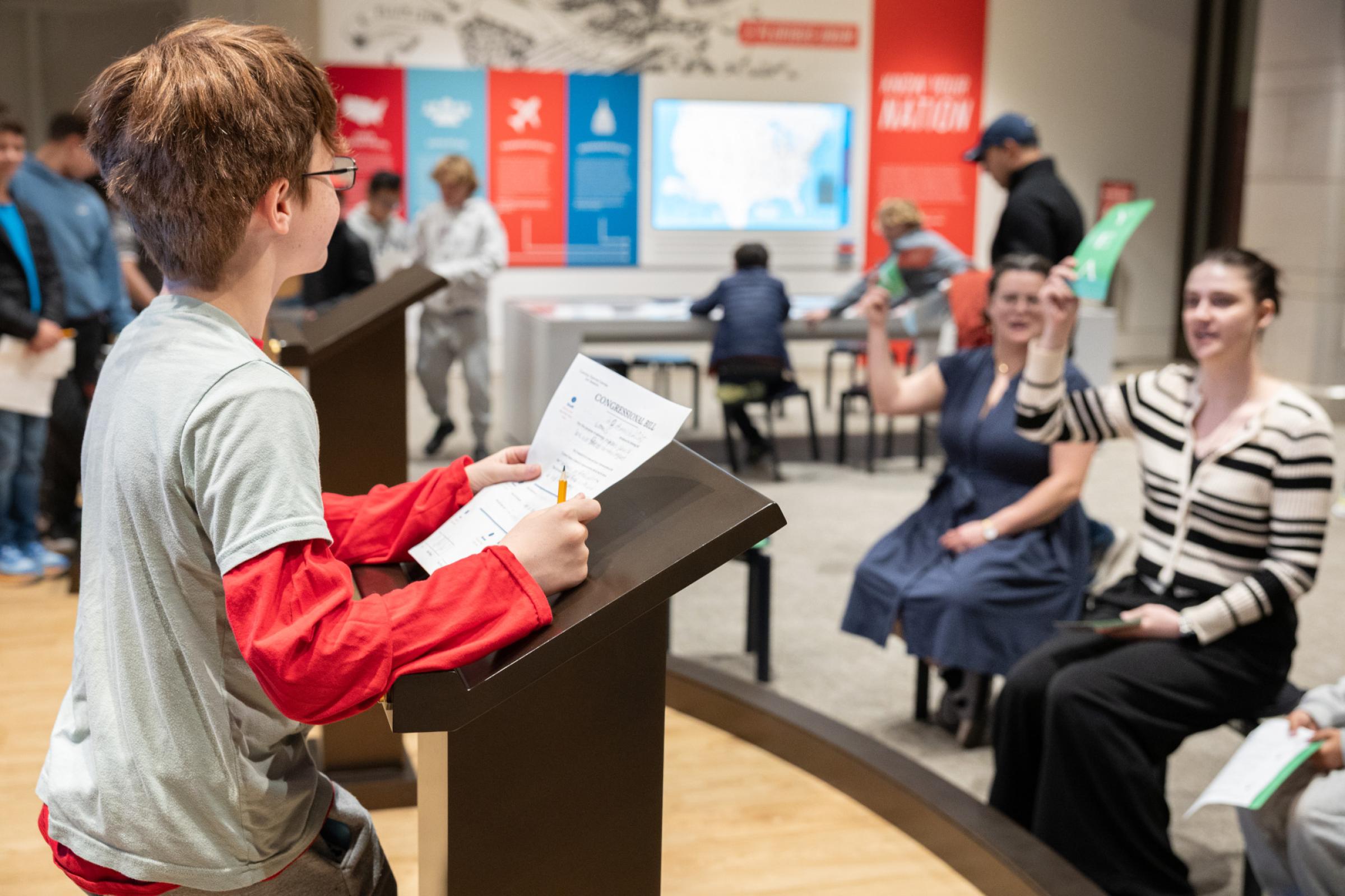 Student standing at a podium. 