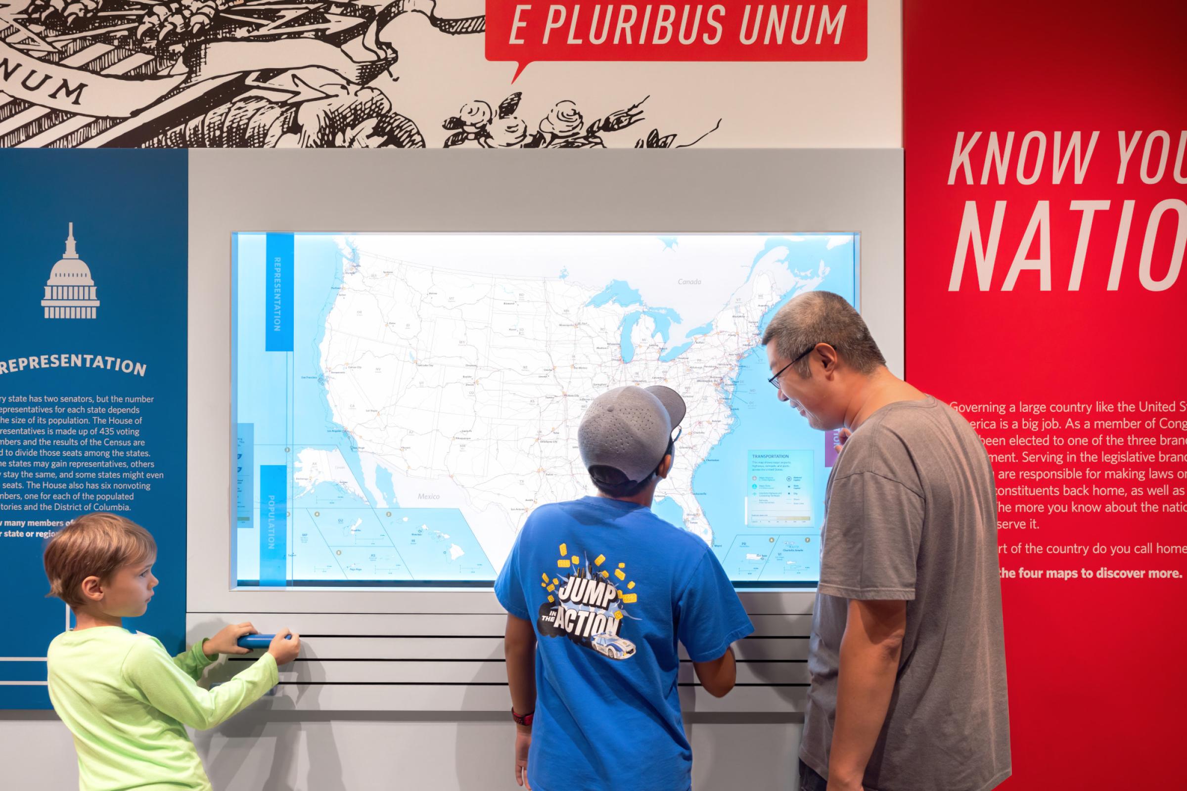 Family standing at the map board. 