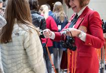 Visitor Guide hands out headsets