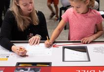 Education specialist with child in Democracy Lab