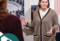 A female talking about information at a display.