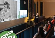 People watching a large screen. 