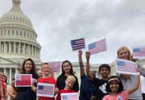 group of students standing outside the Capitol holding paper flags