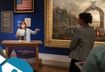 a person gestures to the Colorado painting on display in Exhibition Hall