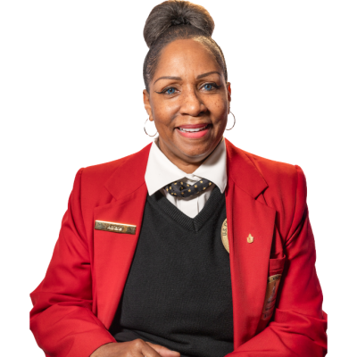 headshot of Adriane Norman wearing a Visitor Guide uniform including red blazer