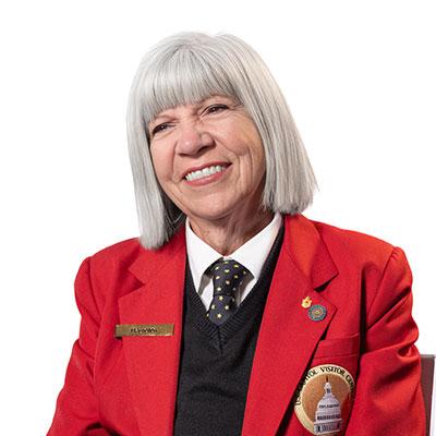 Visitor Guide Maryellen wearing a red blazer and smiling at the camera