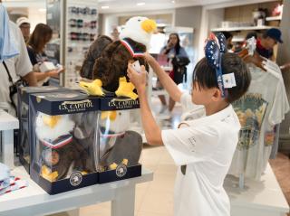 child checking out an eagle plushie in the gift shop