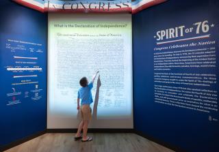 child pointing at the Declaration of Independence animation in the Spirit of '76 special exhibit